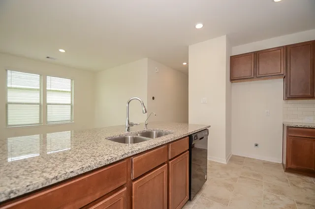 a bathroom with a double vanity sink toilet and shower