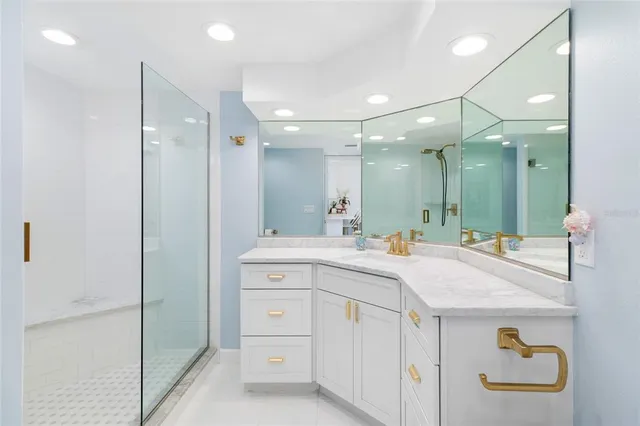 a bathroom with a sink a toilet a large mirror and shower