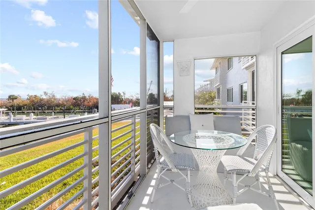 a dining room with furniture and a floor to ceiling window