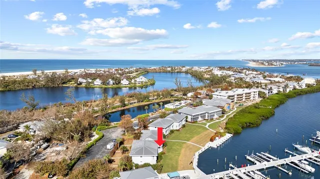 an aerial view of a houses with swimming pool and ocean view