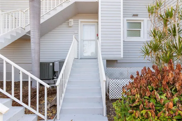 a view of a balcony with wooden floor and fence