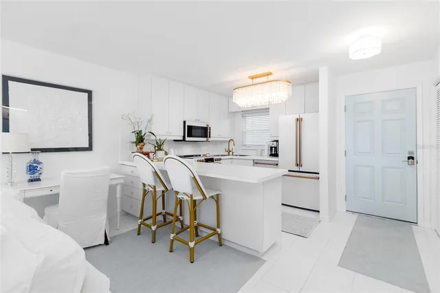 a view of kitchen with sink microwave and refrigerator
