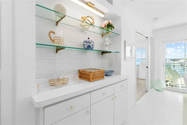 a kitchen with stainless steel appliances granite countertop a sink and a white cabinets