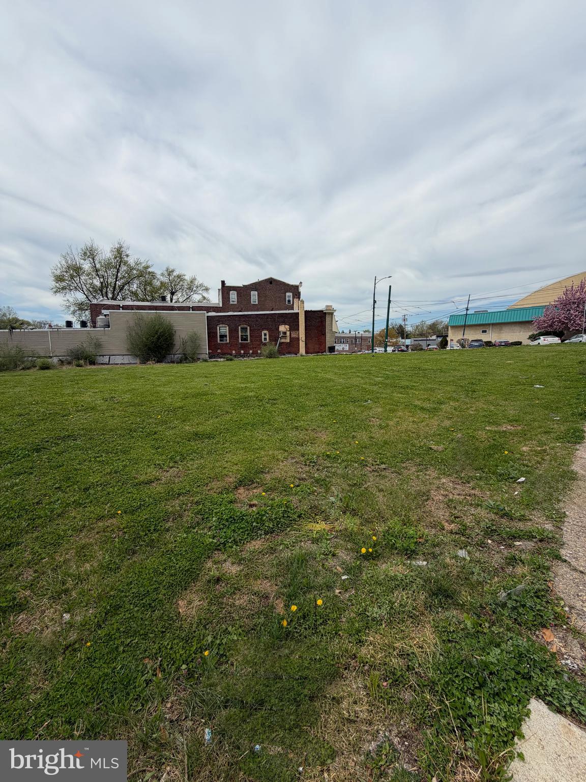 834 Main Street Darby, PA 19023 - Photo 2 of 4 a view of a big room with a big yard and large trees