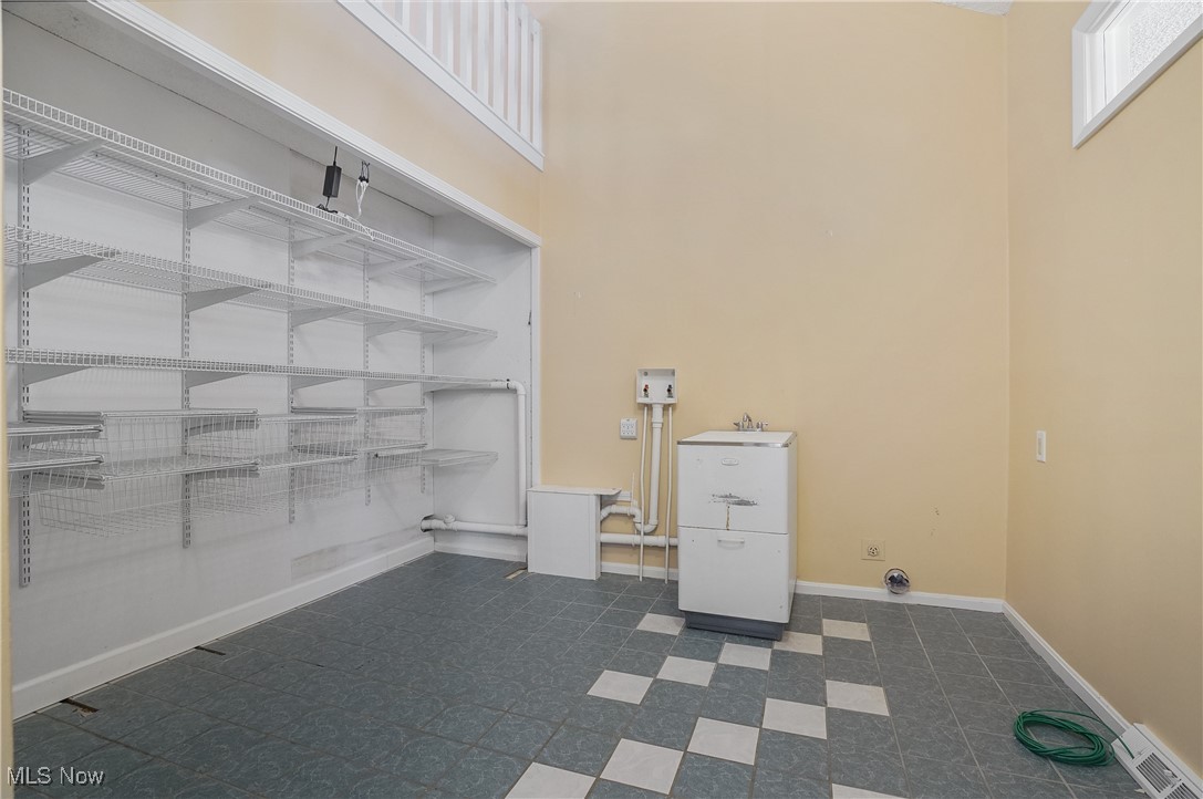 1094 San Raphael Drive Akron, OH 44333 - Photo 23 of 50 Laundry area featuring a high ceiling and baseboards