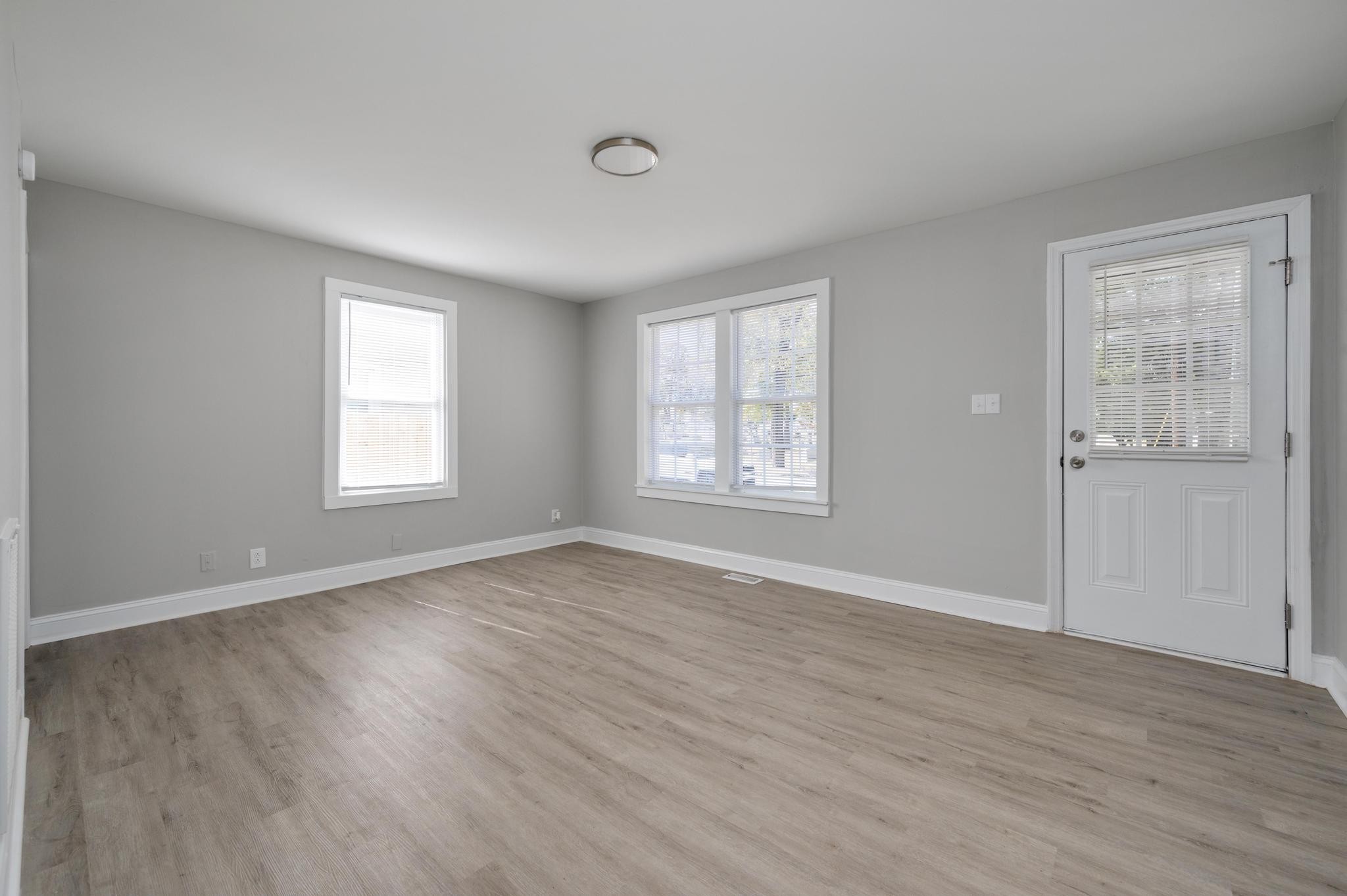 1024 Richard Street Springfield, TN 37172 - Photo 11 of 16 an empty room with wooden floor and windows