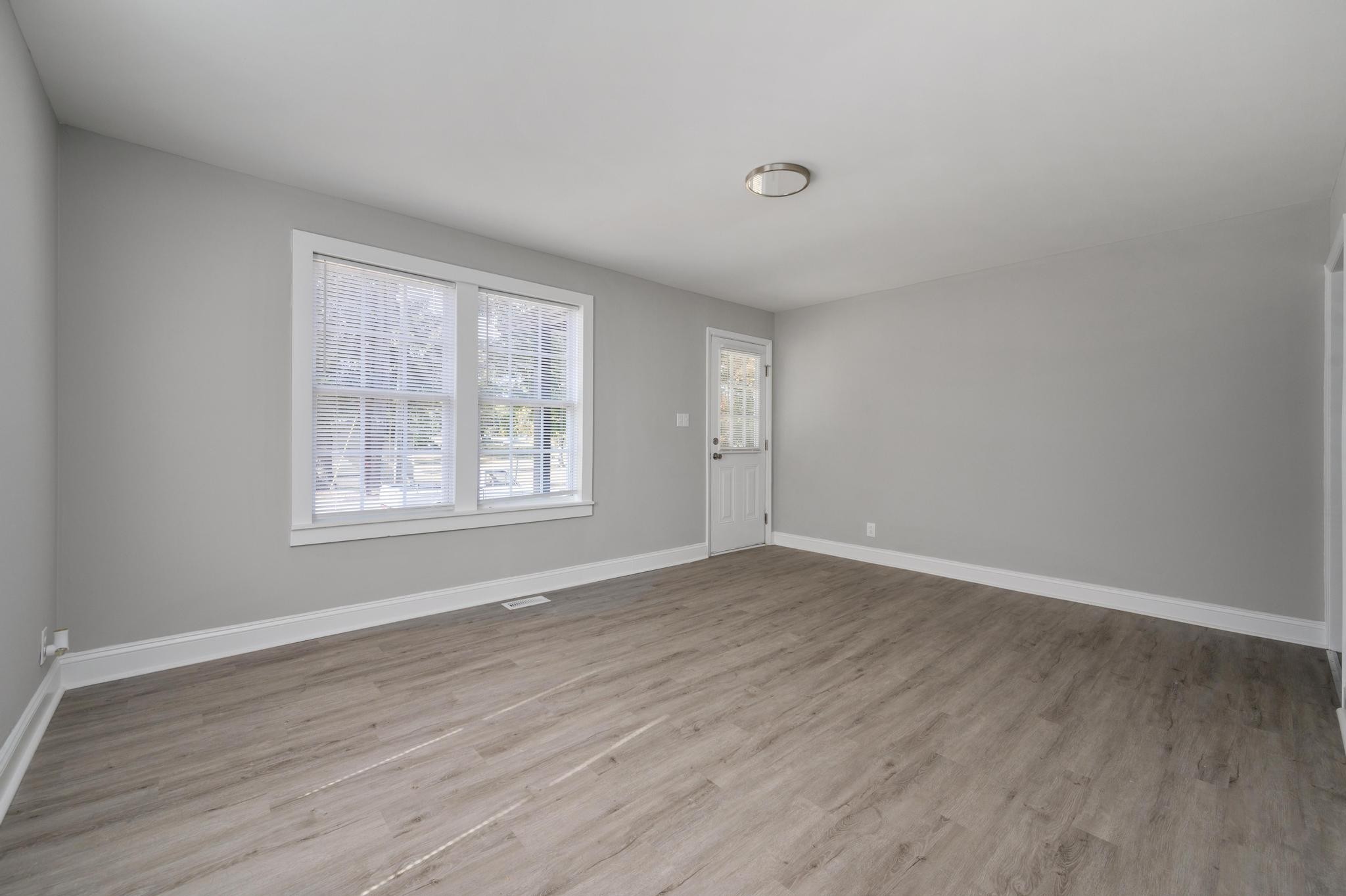 1024 Richard Street Springfield, TN 37172 - Photo 12 of 16 a view of an empty room with wooden floor and a window