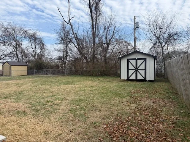 a view of a backyard with large trees