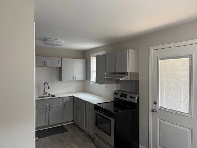 a kitchen with a sink and cabinets
