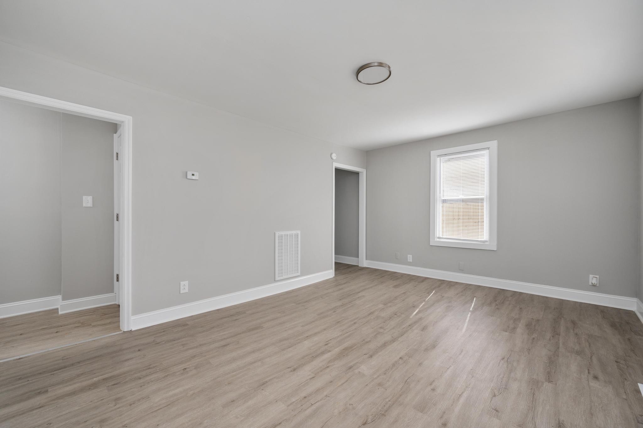 1024 Richard Street Springfield, TN 37172 - Photo 10 of 16 a view of an empty room with wooden floor and a window