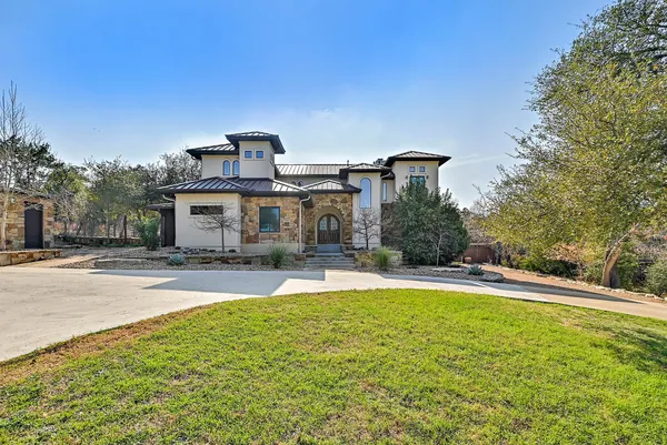 a view of a house with a yard patio and a garden