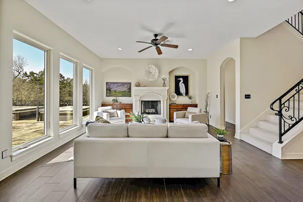 a living room with fireplace furniture and a large window