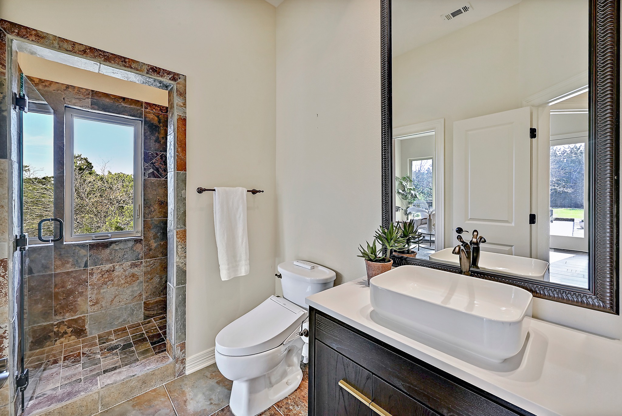 13201 Winding Creek Road Austin, TX 78736 - Photo 15 of 39 a bathroom with a sink toilet a mirror and shower