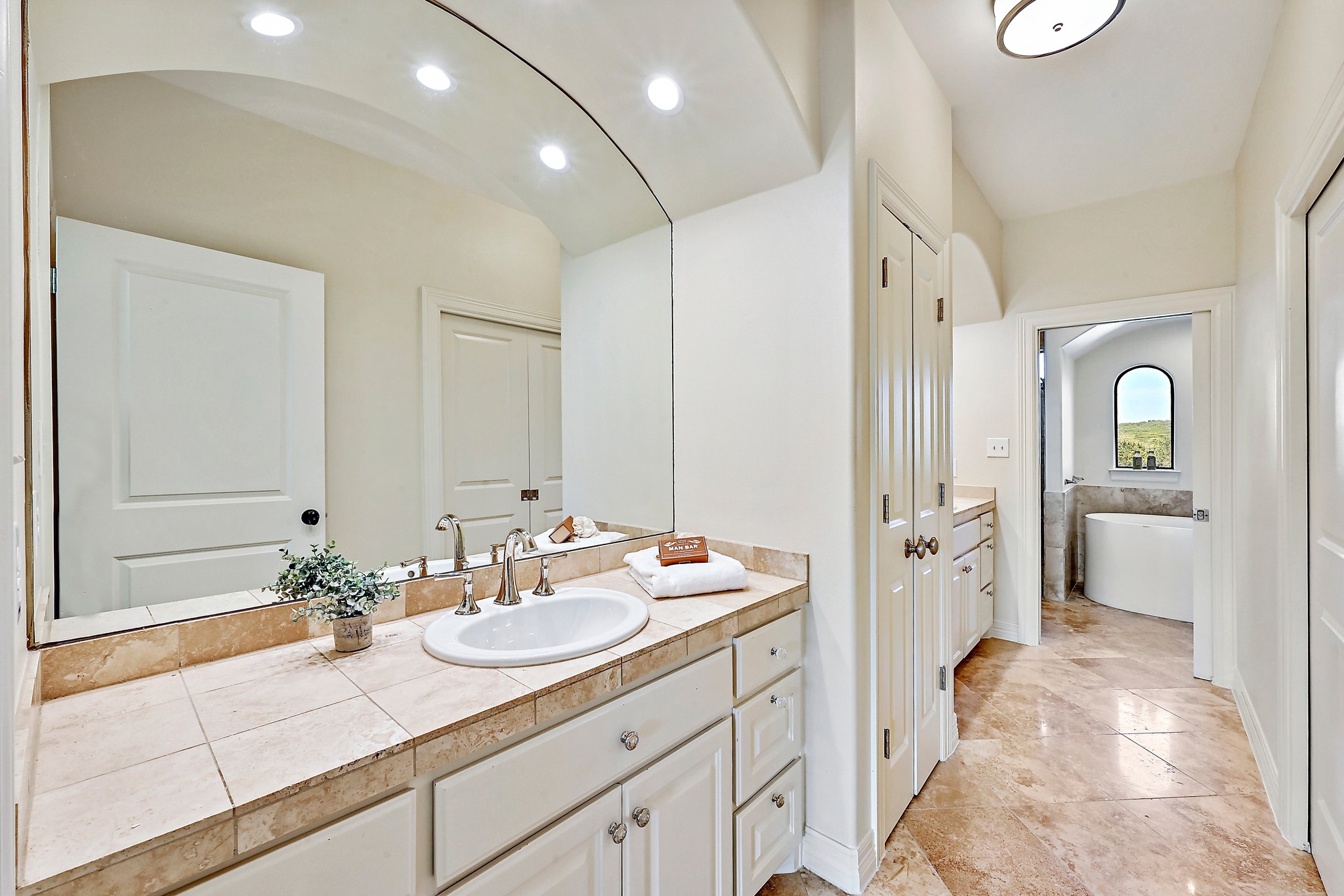 13201 Winding Creek Road Austin, TX 78736 - Photo 20 of 39 a spacious bathroom with a sink double vanity granite and a mirror