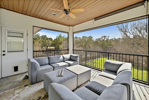 a balcony with furniture and a potted plant