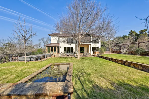 a view of a house with swimming pool and sitting area