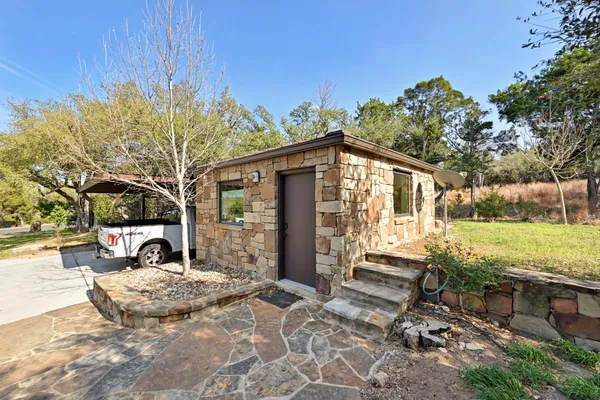 a view of a house with backyard and sitting area