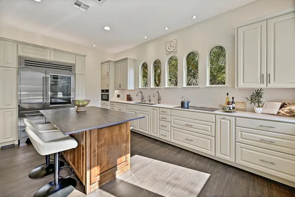 a kitchen with a sink cabinets and window