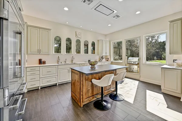 a view of kitchen center island dining table wooden floor and living room view