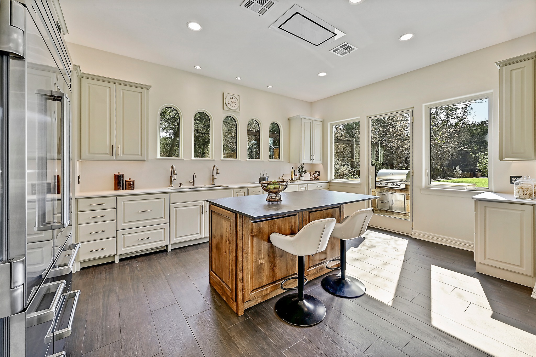 13201 Winding Creek Road Austin, TX 78736 - Photo 5 of 39 a view of kitchen center island dining table wooden floor and living room view