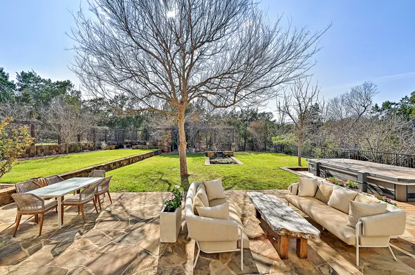 a view of backyard with swimming pool and outdoor seating