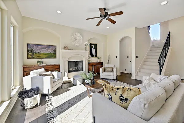 a living room with furniture a fireplace and a flat screen tv