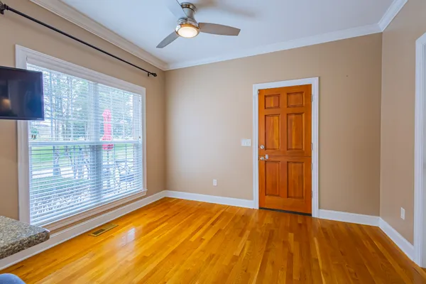 an entryway with wooden floor and a window