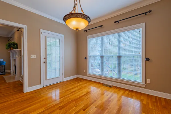 a view of a balcony with wooden floor