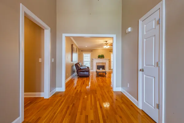 a kitchen with stainless steel appliances granite countertop wooden cabinets a sink and dishwasher with wooden floor