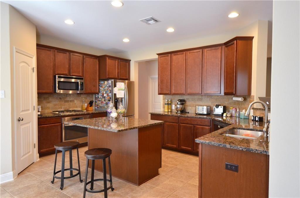 5629 Rio Chama Cove Austin, TX 78738 - Photo 8 of 34 Culinary creations come to life in this spacious kitchen, boasting an island and abundant storage.