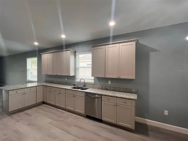 a kitchen with sink and cabinets