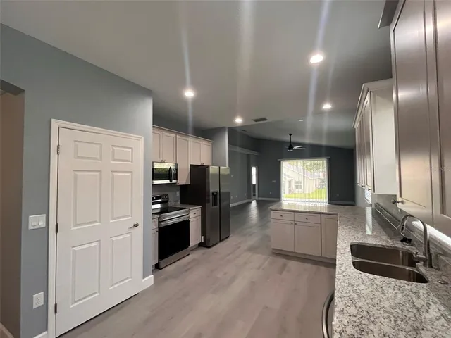 a kitchen with cabinets and stainless steel appliances