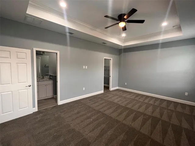 a view of an empty room and a ceiling fan