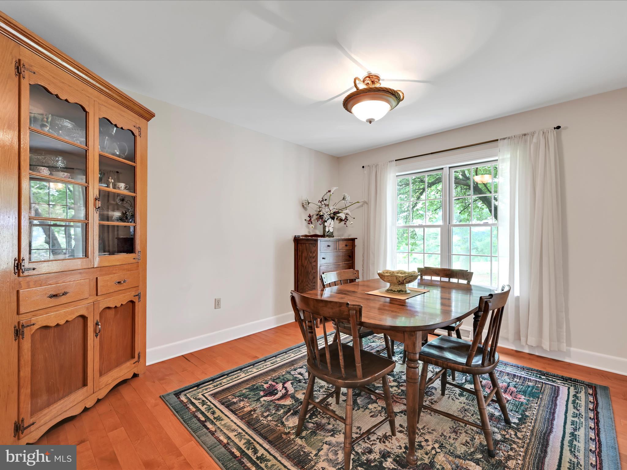 350 Indian Run Road Stevens, PA 17578 - Photo 11 of 72 a dining room with furniture a rug and a window