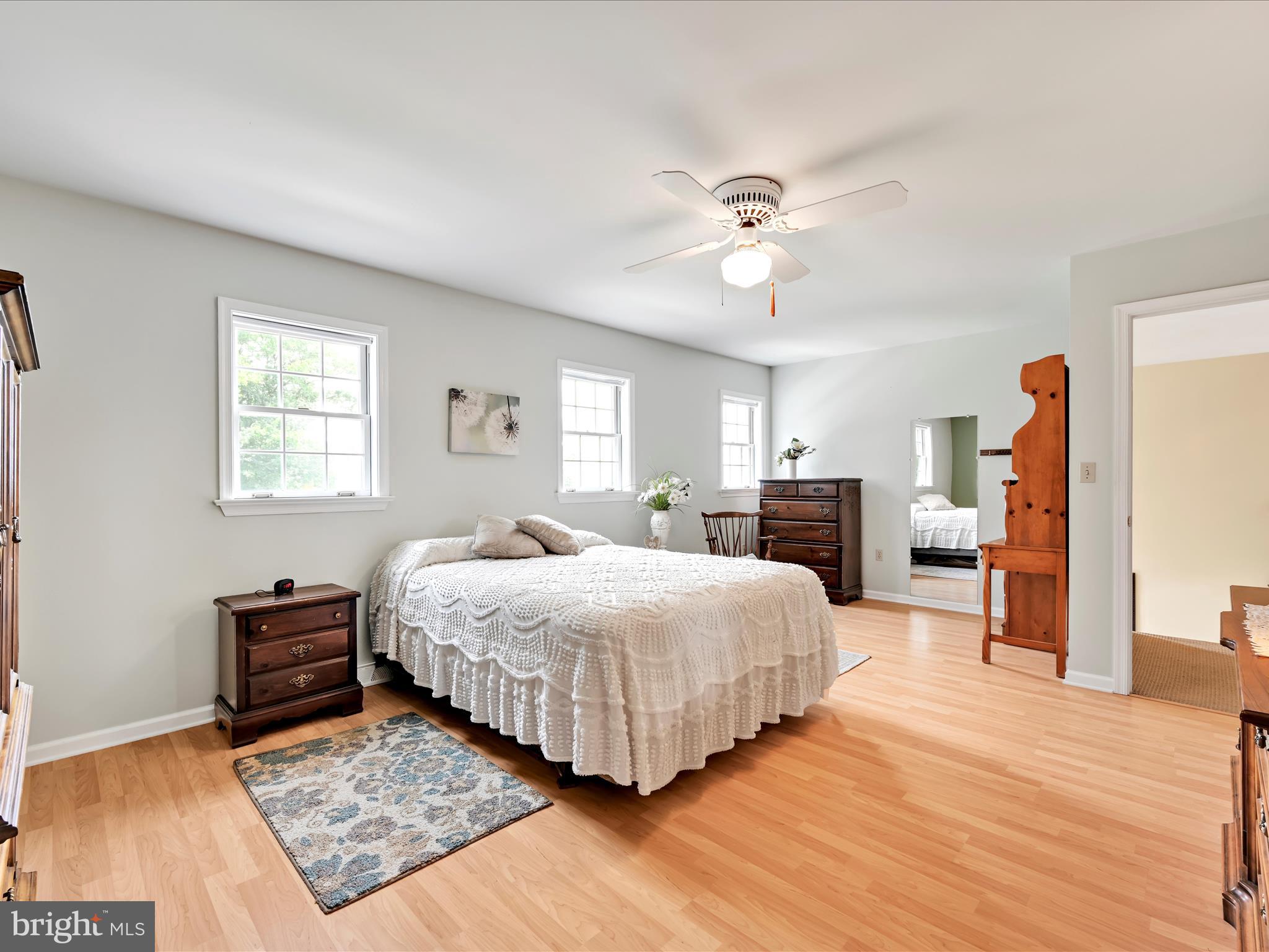 350 Indian Run Road Stevens, PA 17578 - Photo 23 of 72 a bedroom with a large bed and a chandelier
