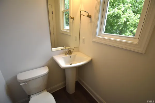 a white toilet sitting next to a white sink