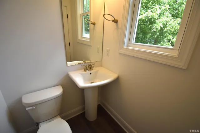 a white toilet sitting next to a white sink