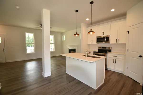 a kitchen with kitchen island white cabinets and white appliances
