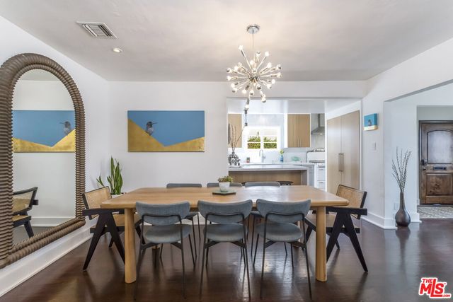 a kitchen with stainless steel appliances a sink a large window and a refrigerator