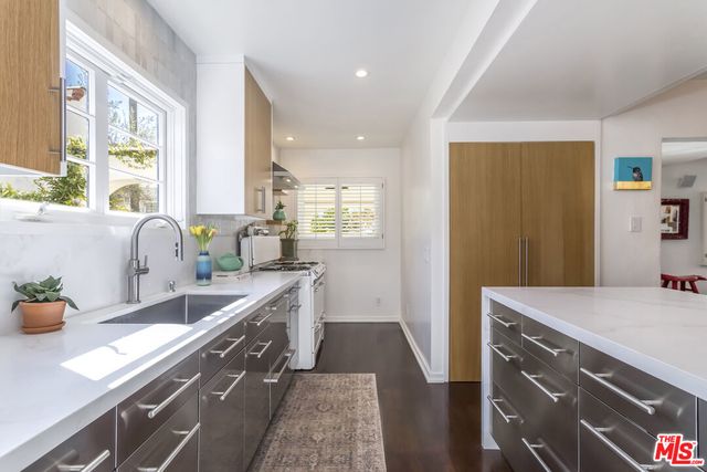 a bathroom with a granite countertop sink a toilet and shower