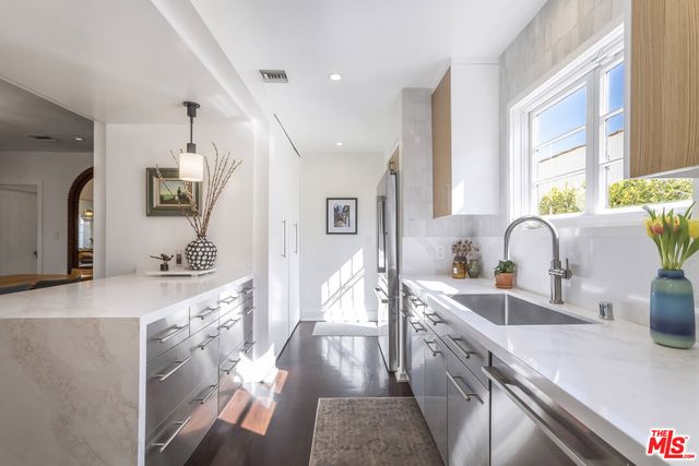 a bedroom with a bed and a potted plant