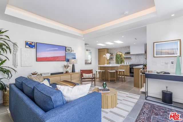 a kitchen with stainless steel appliances kitchen island granite countertop a stove a sink a dining table and chairs