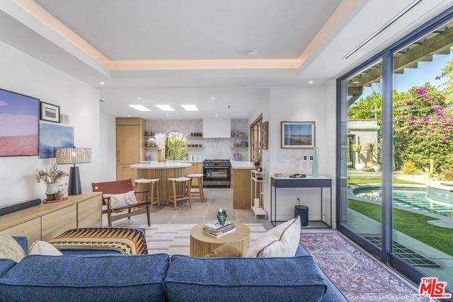 a kitchen with a table chairs a sink and a window