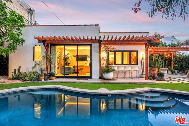 a backyard of a house with garden table and chairs
