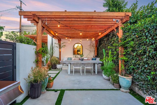 an aerial view of a house with garden space and sitting area