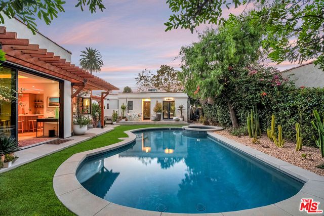 a living room with fireplace furniture and a wooden floor
