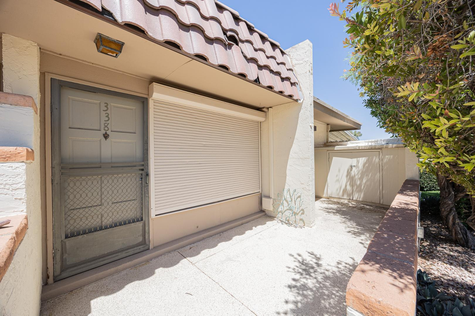 609 South Power Road, Unit 338 Mesa, AZ 85206 - Photo 2 of 24 a backyard of a house with a tree and wooden fence