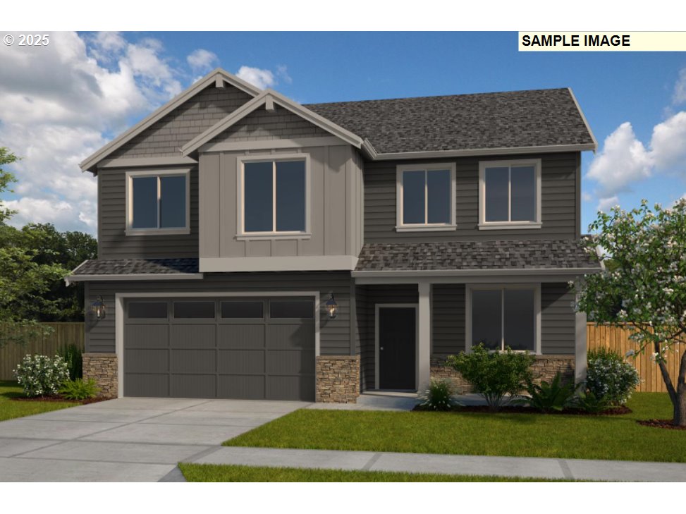 9105 South 3rd Street, Unit 117 Ridgefield, WA 98642 - Photo 1 of 33 a front view of a house with a yard and garage