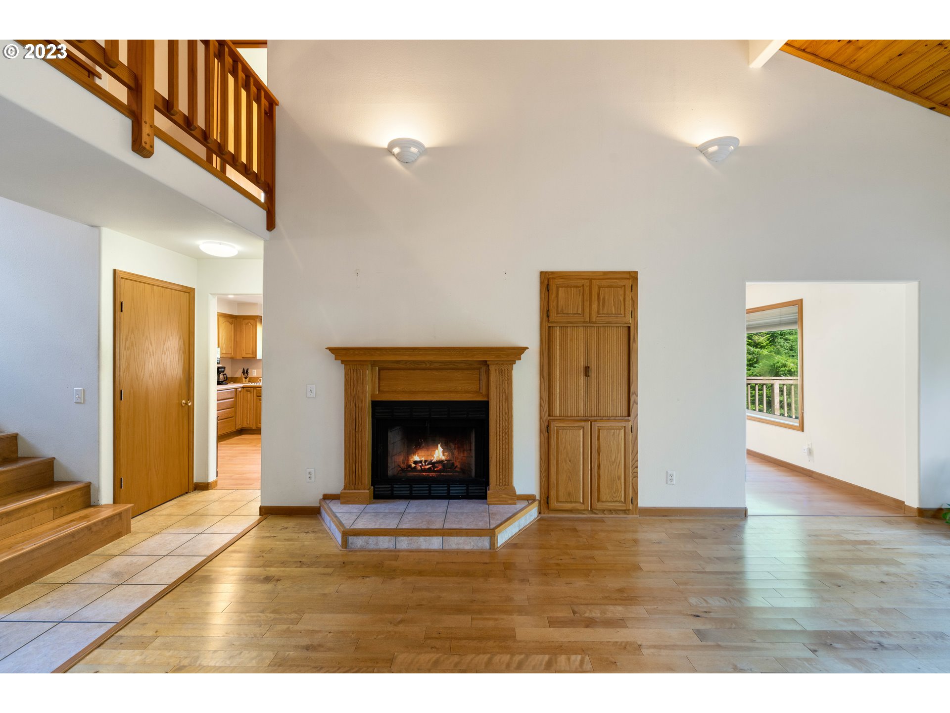87268 Ruby Lane Bandon, OR 97411 - Photo 15 of 47 a view of an empty room with wooden floor fireplace and a window