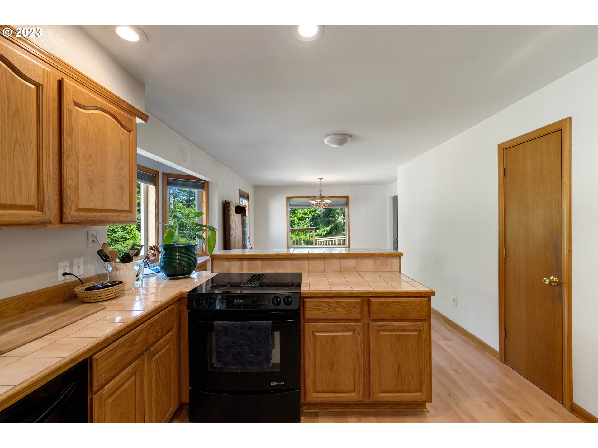 87268 Ruby Lane Bandon, OR 97411 - Photo 22 of 47 a kitchen with granite countertop a sink a stove and wooden cabinets